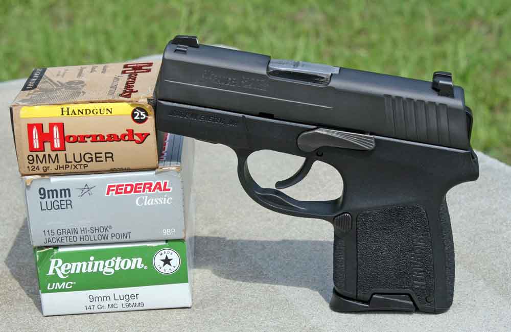 SIG P290RS with ammo on a bench.