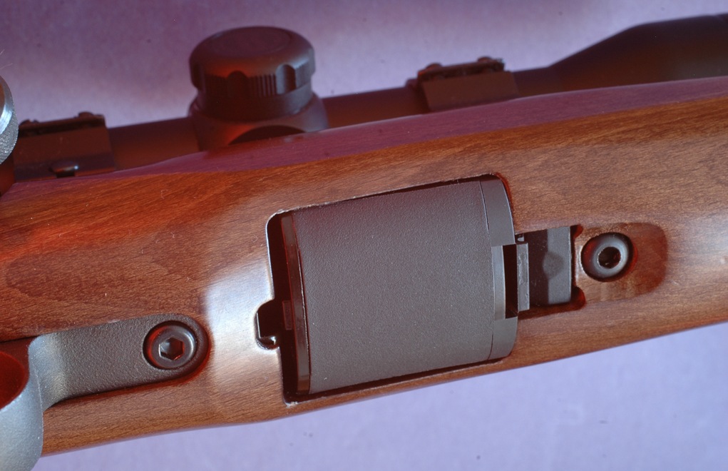 The 10-shot rotary magazine fits flush between the action screws, and the forward latch is properly recessed.