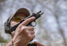 Springfield SA-35 4-Inch Review: The Baby Hi-Power The Springfield SA-35 4-Inch with its slide locked back and a magazine being inserted.