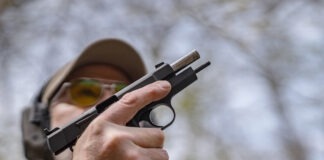Springfield SA-35 4-Inch Review: The Baby Hi-Power The Springfield SA-35 4-Inch with its slide locked back and a magazine being inserted.