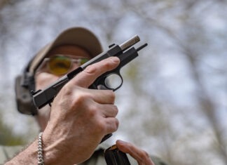 Springfield SA-35 4-Inch Review: The Baby Hi-Power The Springfield SA-35 4-Inch with its slide locked back and a magazine being inserted.