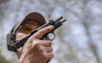Springfield SA-35 4-Inch Review: The Baby Hi-Power The Springfield SA-35 4-Inch with its slide locked back and a magazine being inserted.