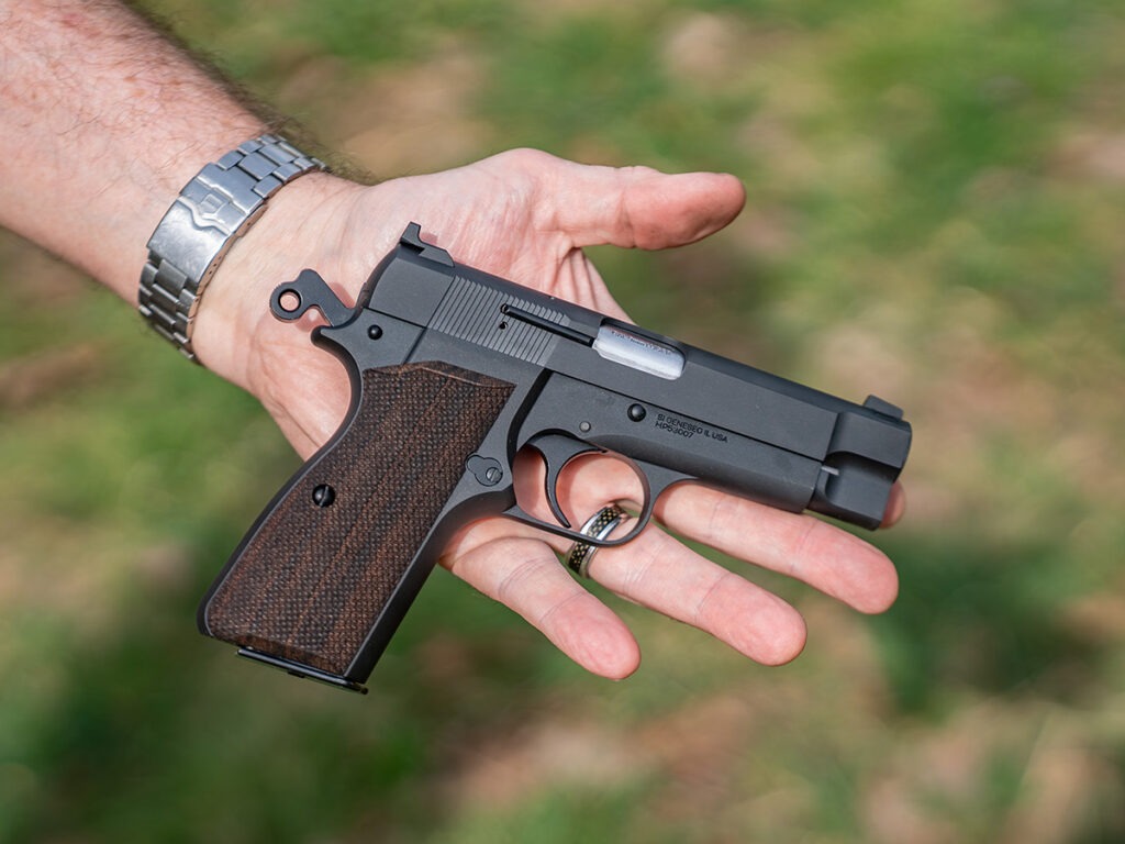 The Springfield SA-35 4-Inch being held in the palm of a hand showing its size.