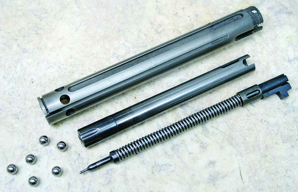 On the SR30, the handle movement is along the horizontal plane, as on the Browning T-bolt. And, as on the other straight-pulls, the bolt glide is silky smooth. Lockup is achieved with six ball bearings wedged outward to engage an annular groove in the receiver ring, as shown here with the components comprising the Heym bolt’s ball bearing locking system.