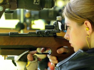 A practiced off-hand target competitor. Her rifle is just that, a rifle.