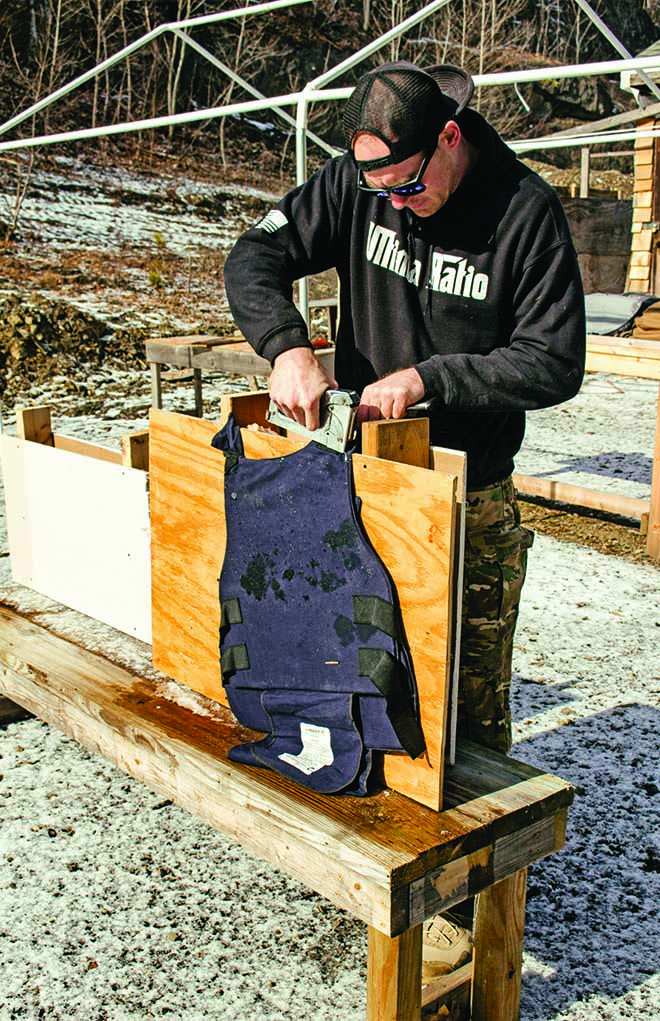 Mark Nazi of Double Eagle Tactical Training staples a used bulletproof vest to the rear of the mock wall in order to stop and recover bullets in this "backyard" terminal ballistics test.