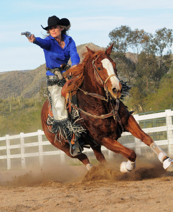 With six guns a blazing, Kenda Lenseigne puts her horse through its paces