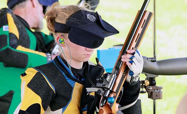 Amy Fister checks the chamber of her gun in between shots at the NRA 3-Position Championship at Camp Perry, Ohio.