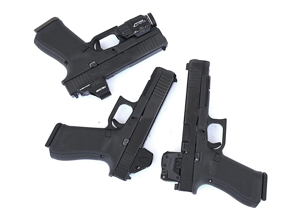 Three Glock pistols equipped with red-dot sights on a white background.