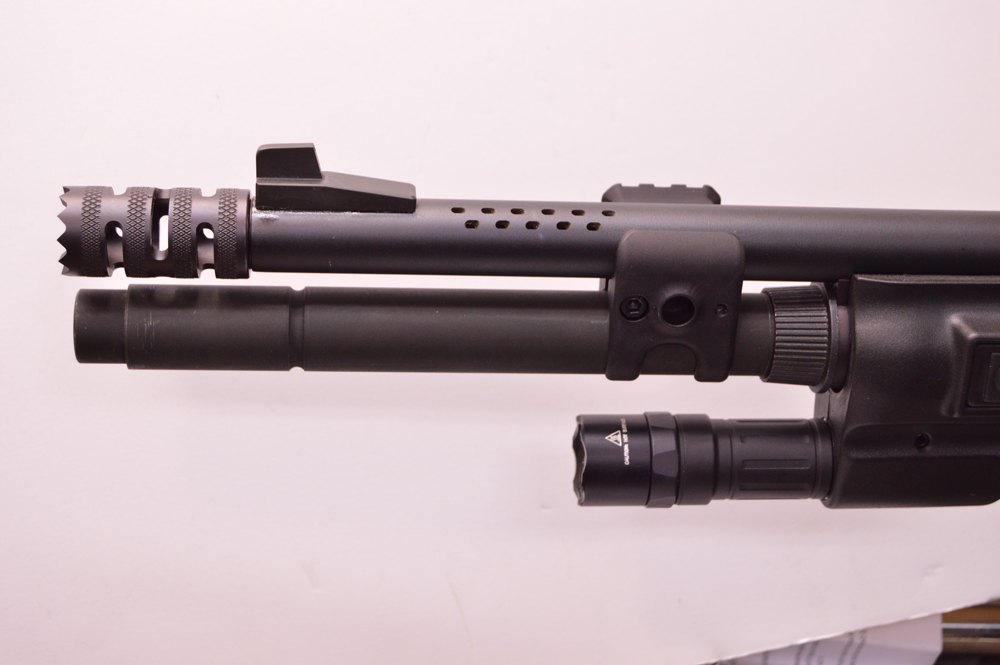The breacher, Scattergun Technologies sights, Mag-na-porting, elongated forcing cone, long mag tube, and the Surefire light are all installed.