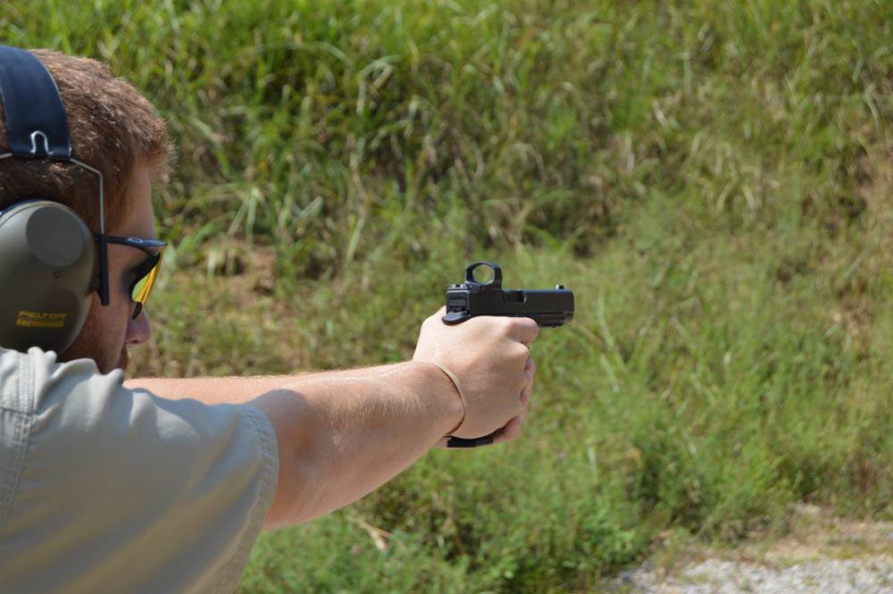 This shooter shows good form with a high grip on the gun, shoulders rolled forward, with elbows with good tension but not stiff, and his upper body leaning forward to control the recoil of the G35 in 40 S&W.