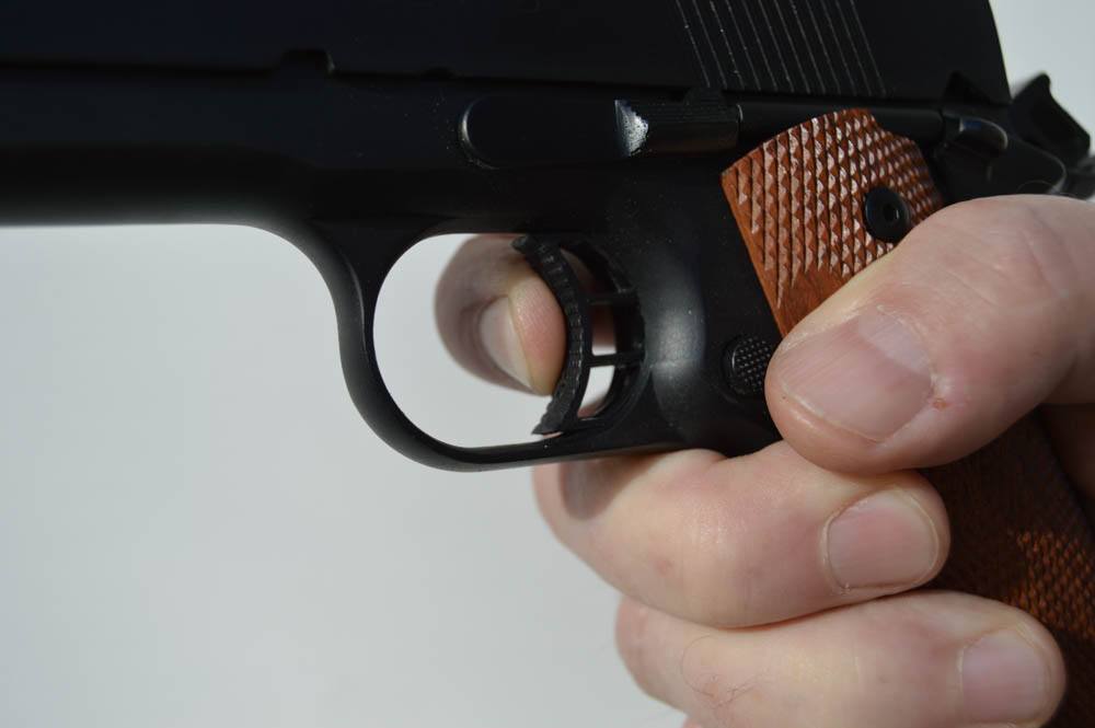 Trigger finger placement is very important no matter what shooting discipline you are engaged in. Here, there is too little trigger finger applying pressure. This finger position will likely cause the pressure on the trigger to be applied to the left side, and not straight to the rear as it should be.