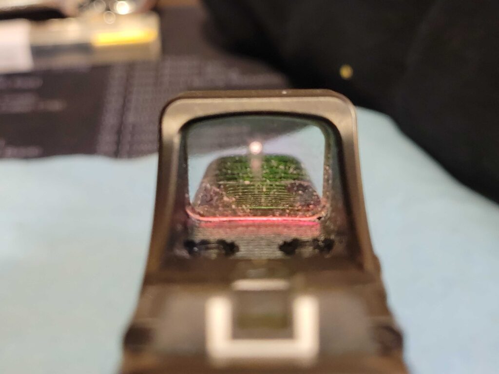 A very dirty Holosun SCS red dot lens.