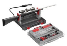 Hardware Talk: Real Avid Bore-Max Master Cleaning Kit The Real Avid Bore-Max Master Cleaning Kit & Workstation with a rifle in its rifle rest on a white background.