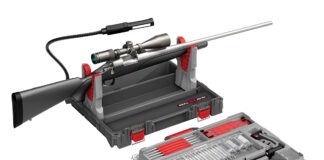 Hardware Talk: Real Avid Bore-Max Master Cleaning Kit The Real Avid Bore-Max Master Cleaning Kit & Workstation with a rifle in its rifle rest on a white background.