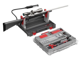 Hardware Talk: Real Avid Bore-Max Master Cleaning Kit The Real Avid Bore-Max Master Cleaning Kit & Workstation with a rifle in its rifle rest on a white background.
