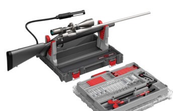 Hardware Talk: Real Avid Bore-Max Master Cleaning Kit The Real Avid Bore-Max Master Cleaning Kit & Workstation with a rifle in its rifle rest on a white background.
